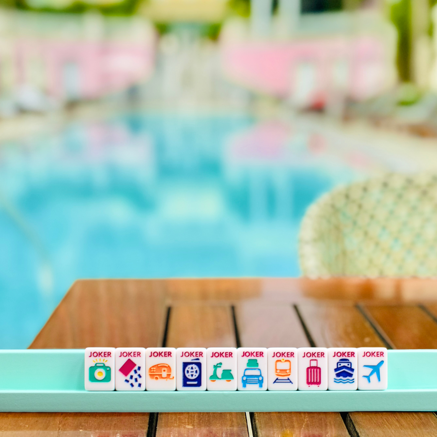 Poolside table with travel-themed jokers mahjong set